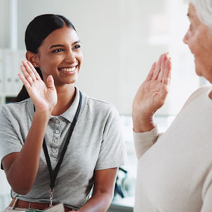 Friendly nurse high fiving a patient