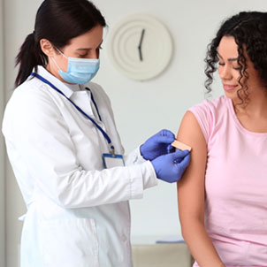 Image of nurse dressing a patient's wounds