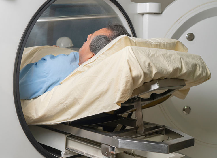 Man inside the hyperbaric oxygen champer for therapy